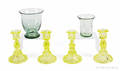 Four vaseline glass candlesticks
