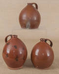 Three redware ovoid jugs 19th c