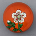 St Louis floral paperweight on an orange ground