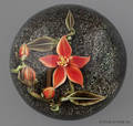 Joshua Steindler floral paperweight with an orange blossom on a sand ground