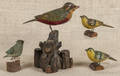 Three carved and painted songbirds