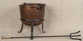 Twelvegallon copper kettle with a wrought iron stand