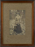 Early photograph of a woman with a shotgun and dead game