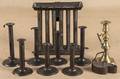 Seven tin hogscraper candlesticks