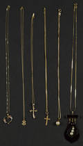 Six gold necklaces with various pendants