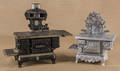 Two cast iron toy stoves