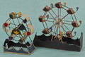 Two painted tin Ferris wheels