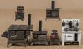 Six cast iron toy stoves