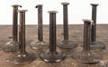 Seven tin hogscraper candlesticks