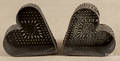 Two tin heartshaped cheese strainers