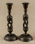 Two painted and gilt decorated wood candlesticks