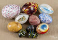 Eleven glass and stone eggs