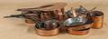 Thirteen copper cooking pots and pans