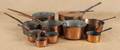 Ten copper cooking pots and pans