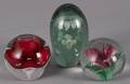 Three floral glass paperweights