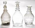 Three blown molded colorless glass decanters