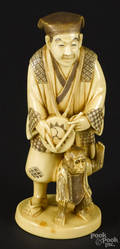 Japanese Meiji period carved ivory figure of a man with a monkey