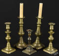 Two pairs of antique brass candlesticks