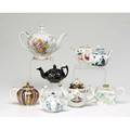 Collection of eight teapots including a jackfield style 19th c and large teapot with transfer decoration early 20th c the others reproduction japanese teapots of various wares tallest 6