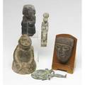 Egyptian artifacts carved stone fragment of a male head fitted on a wooden stand a bronze seated figure of sekhmet and a bronze mirror together with two other ethnographic stone carvings of unknown