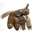 African artifacts seven items four masks gourd bottle with applied shells having a horn neck and spout carved primitive wooden figure fly whisk with wooden handle mask 20