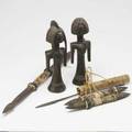 Tribal art two carved wood african figures together with four pacific island daggers 20thc largest 29