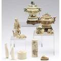 Asian ivory eleven pieces two carved ivory covered jars arachaicstyle decoration both with wooden bases together with a japanese okimono oval horn box with incised decoration and hinged lid two