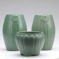 Zanesville stoneware three pieces covered in matte green glaze including a pair of ovoid vases with flowers unmarked tallest 8 12