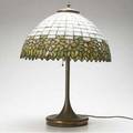 Lighting american glass and bronze table lamp the leaded geometric shade with floral border below a white ground unmarked 23 x 16