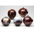 Tom turner five porcelain vessels two covered in oxblood with copper flambe and purple teadust glazes all signed tallest 10 x 7 dia