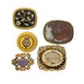 Five georgian or victorian brooches faceted oval citrine embossed and engraved mount mottled agate embossed mount half pearl flowering vine motif black enameled ground engraved mount oval face