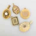 Five victorian yellow gold lockets oval with engraved scrolling floral motif over textured ground linear black enameled square booklet with daguerreotypes oval built filigree with bezel set pearls