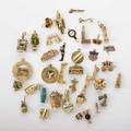 Thirtyeight travel  novelty yellow gold charms includes american and uk souvenir and bar related charms etc 918k 554 dwt property from the collection of gray davis boone