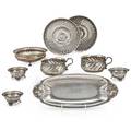 American and foreign ornamental silver holloware ten pieces four coin silver dishes with ball and paw feet unmarked international sterling bread tray in the danish style reticulated sterling bonb
