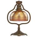 Tiffany studios desk lamp with wave pattern shade and zodiac base new york 1900s parcel gilt bronze favrile glass single socket shade signed lct favrile base stamped tiffany studios new y