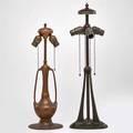 Handel etc handel buttressed table lamp base together with an urn shaped lamp base late 19thearly 20th c patinated metal brass 
