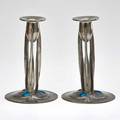Liberty tudric pair of pewter candlesticks each decorated with enameled copper cabochons england ca 1900 stamped english pewter made in england 9 tall 6 dia
