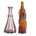 Indian herb bitters bottle indian queen in amber glass together with pittsburgh glass amethyst ribbed decanter american 19th c bottle embossed with patent date feb 11 1868 tallest 12 14 pro