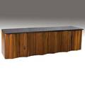 Phillip lloyd powell wallhanging credenza with slate top over six pairs of sculpted walnut doors enclosing interior fitted drawers dividers and shelves 27 x 96 x 23