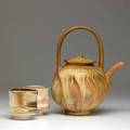 Tom coleman gasfired stoneware teapot with a pair of woodfired porcelain cups each signed 11 34 x 9 cups each 3 12 x 3 12 approx
