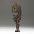 Karawari hook figure papua new guinea carved wooden charm of abstracted human form on custom display stand earlymid 20th c such idols were carved as charms for a successful hunt
