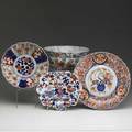 Japanese porcelain mixed lot of four pieces includes three imari design bowls one charger and an early polychrome deep bowl with stapled repairs largest 5 12 x 10 12