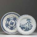 Delft two chargers one with floral decoration the other with landscape decoration 18th c larger 14 34 dia