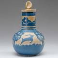 North dakota school of mines lidded vase by sonia rimestad with leaping gazelles and blossoming trees in indigo on buff ground 1956 blue ink stamp artists mark and date 10 12 x 6