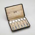 Liberty  co set of six enameled sterling silver tea spoons probably designed by archibald knox with stylized leaf design in original silklined box some stains to silk lining tears to edges of b