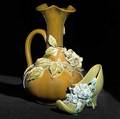 Chelsea keramic art works two vessels with applied blossoms a pitcher and a shoe some losses to decoration on shoe grinding chips to pitcher stamped ckaw 9 34 and 4