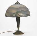 Pittsburgh table lamp with an obversepainted glass shade in european coastal scene over a bronzed twosocket base some chips to patina replaced caps minor chips to fitter unmarked 21 x 16