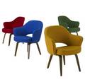 Eero saarinen  knoll set of four armchairs upholstered in red blue yellow and green wool on wooden legs all with knoll upholstery labels 31 34 x 26 12 x 20 12