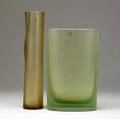 Venini two satinfinished glass vases one cylindershaped in light amber ego designed by p farina 2004 the other of elliptical shape with ribs in light green 2001 both signed and dated als