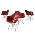 Charles and ray eames  herman miller set of four red fiberglass armchairs on eiffel tower bases embossed mark 30 34 x 25 x 18 12